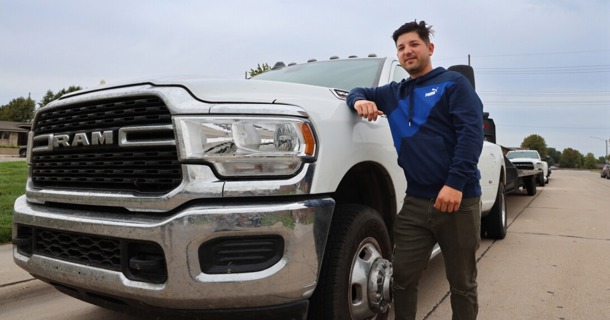 Joel Yera stands next to one of the two trucks he drives as part of his business, Yera Transportation, in Grand Island, Nebraska. Yera recently became the 1,000th entrepreneur in Nebraska to open a business with assistance from Rural Prosperity Nebraska’s Small Business Program. (Russell Shaffer/Rural Prosperity Nebraska)